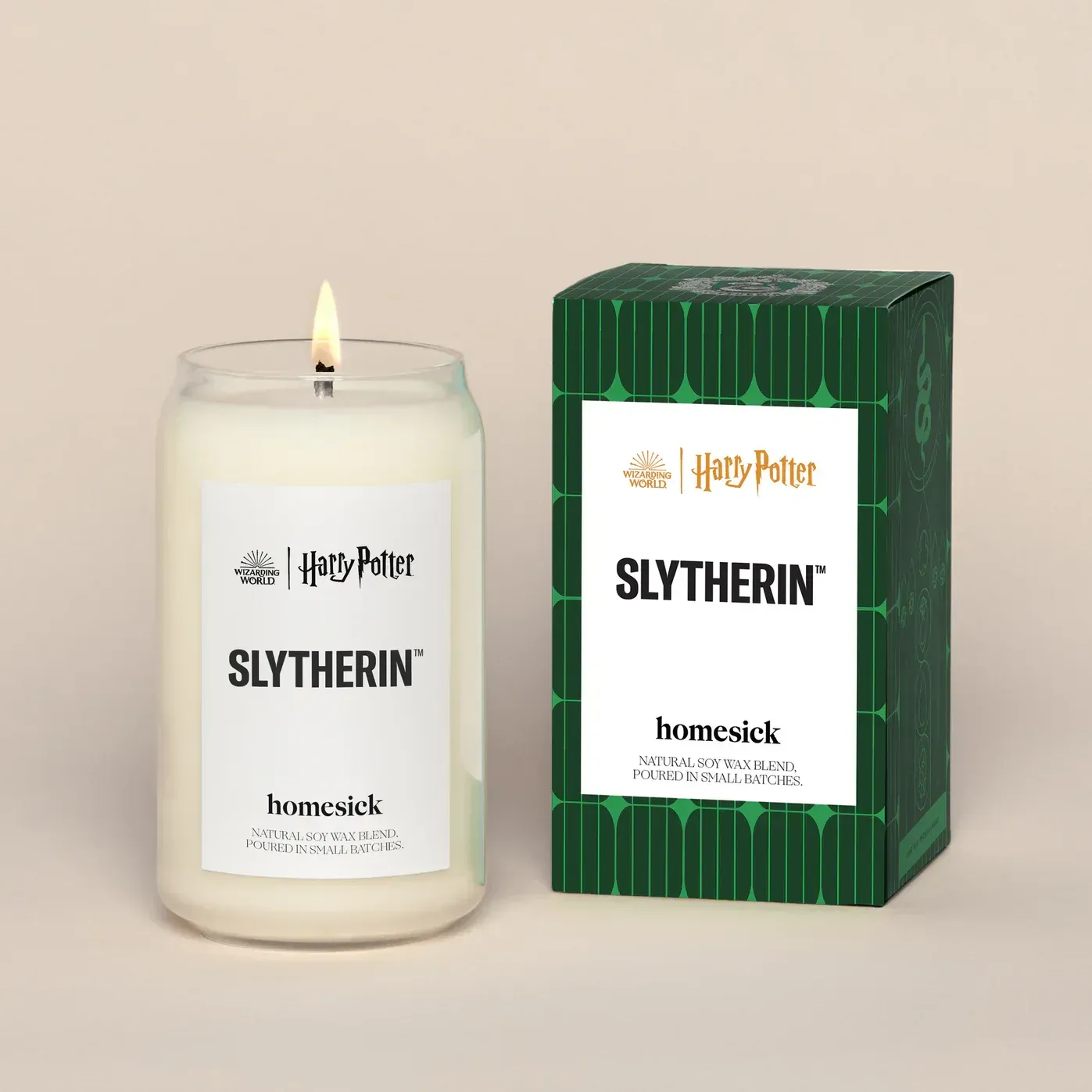 A candle that says slytherin next to a box
