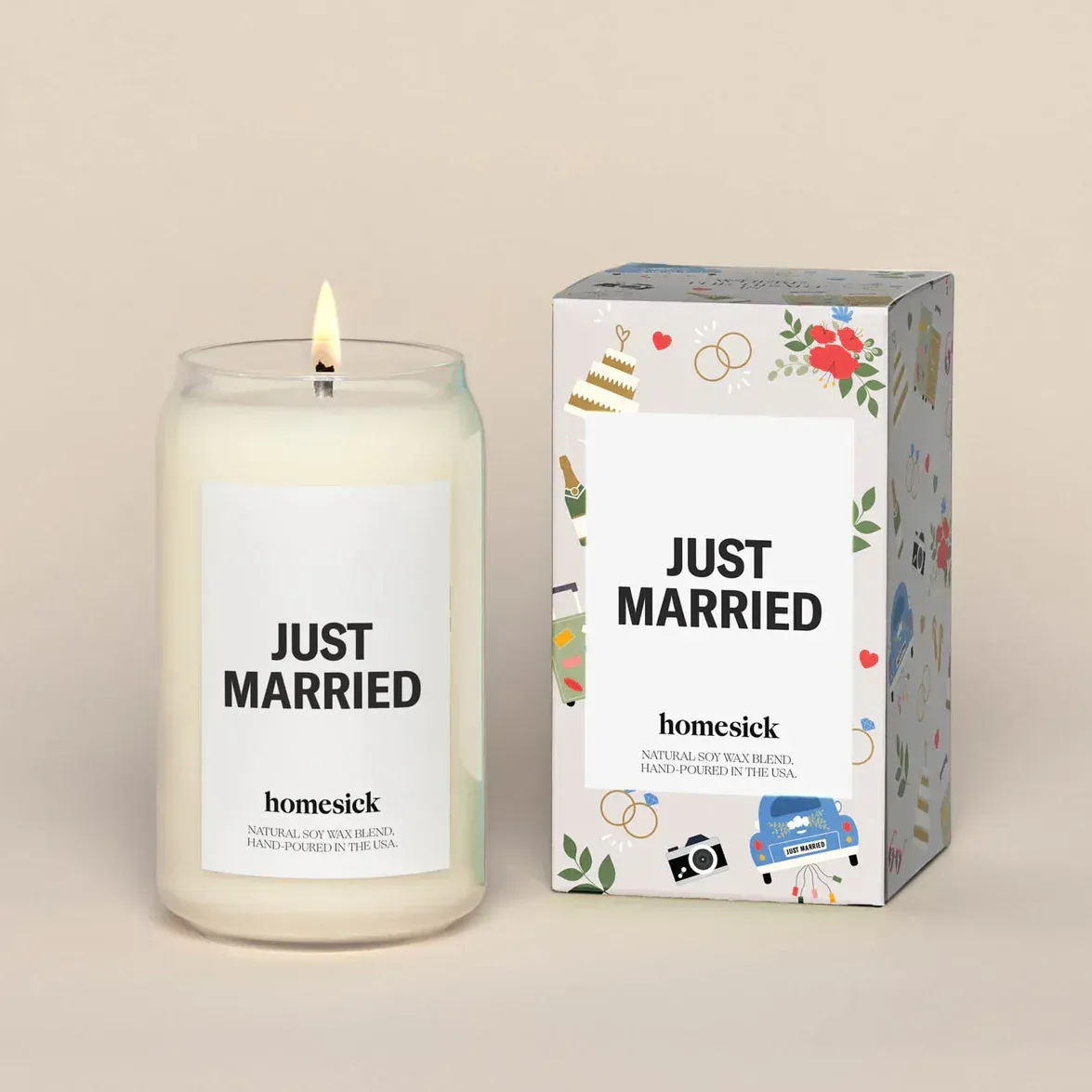 A candle that says `` just married '' next to a box.