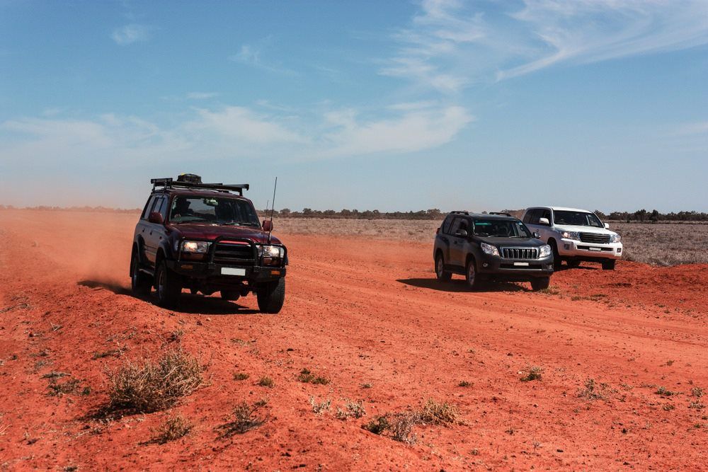 Multiple 4WD Cars On A Soil Road — Tagalong Tours in Cairns, QLD