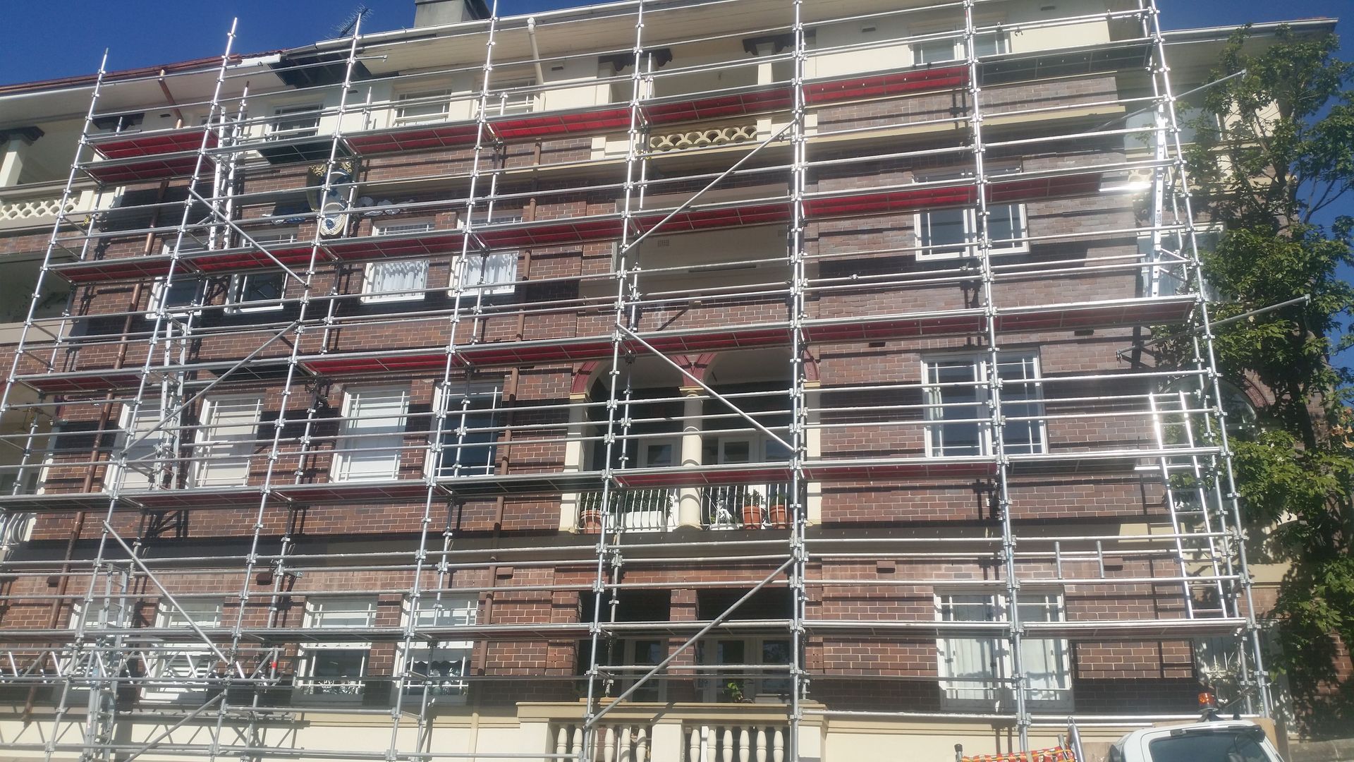 A building under construction with scaffolding on the side of it.