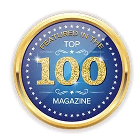 A blue and gold badge that says featured in the top 100 magazine