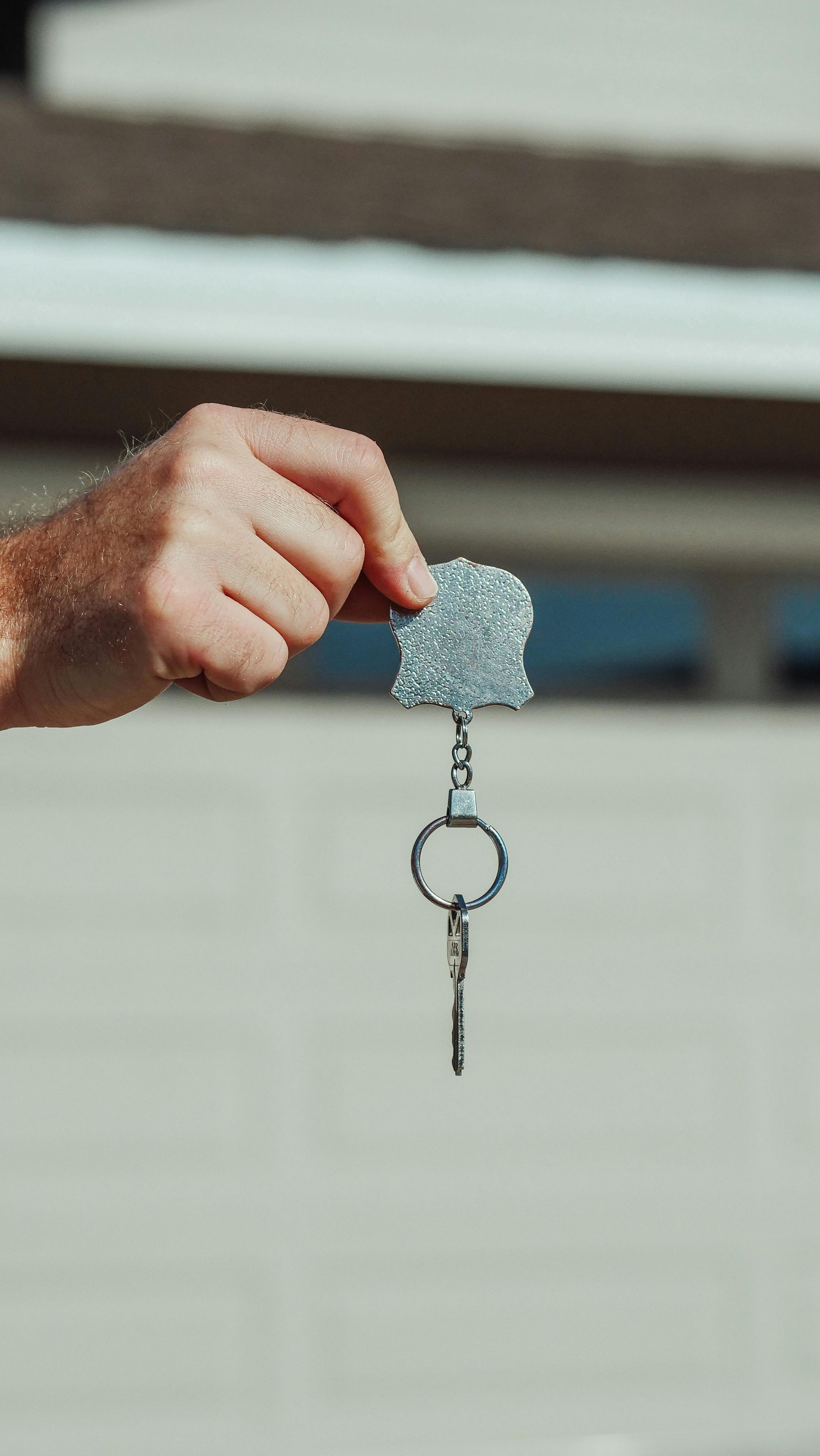 A person is holding a keychain in their hand.