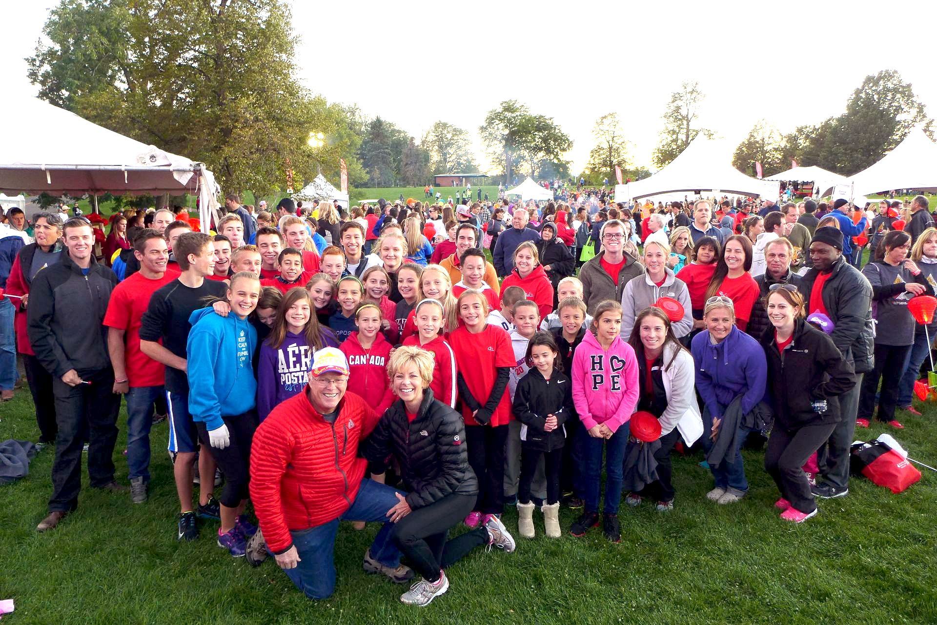 A large group of people are posing for a picture in a field.