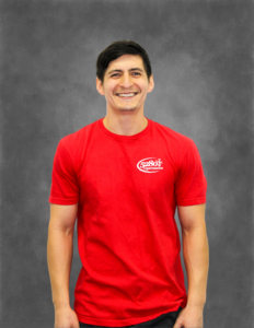 A man wearing a red t-shirt with the word carmel on it