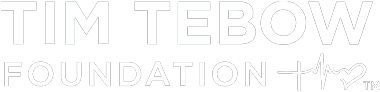 The Tim Tebow Foundation logo featuring white text and a stylized cross and heartbeat icon.