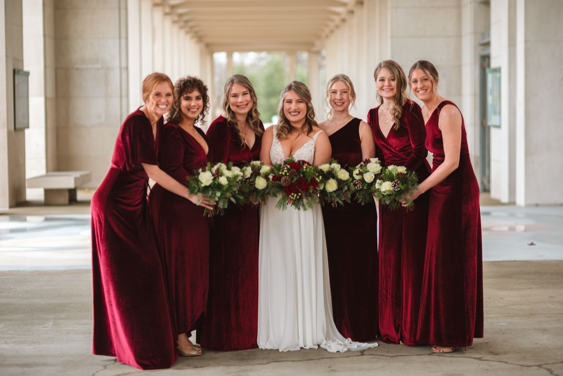 a bride and her bridesmaids are posing for a picture .