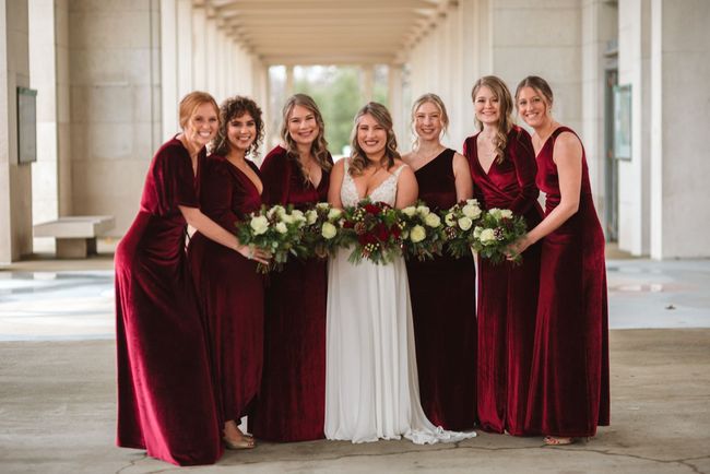 a bride and her bridesmaids are posing for a picture .