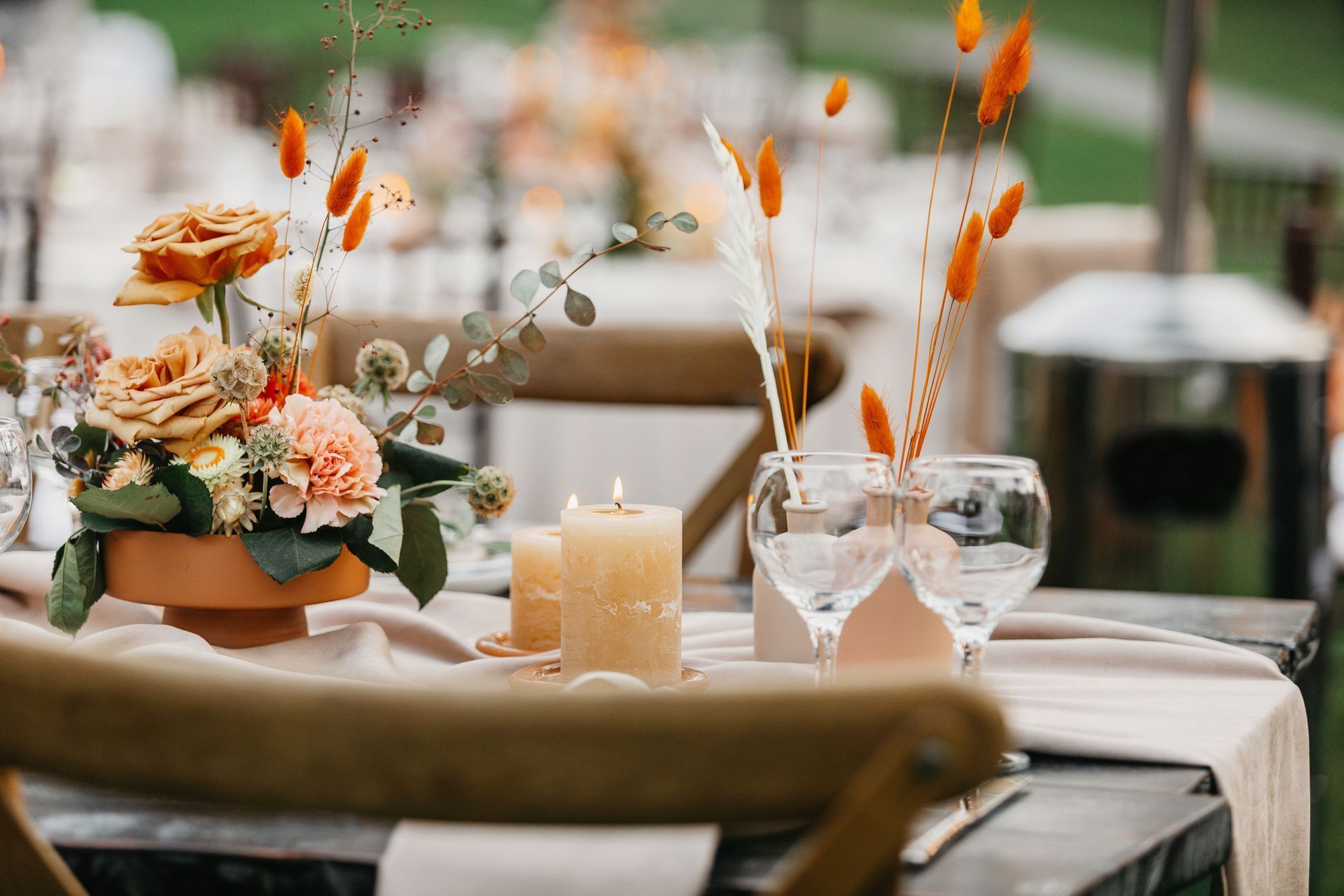 a table with a vase of flowers and candles on it .