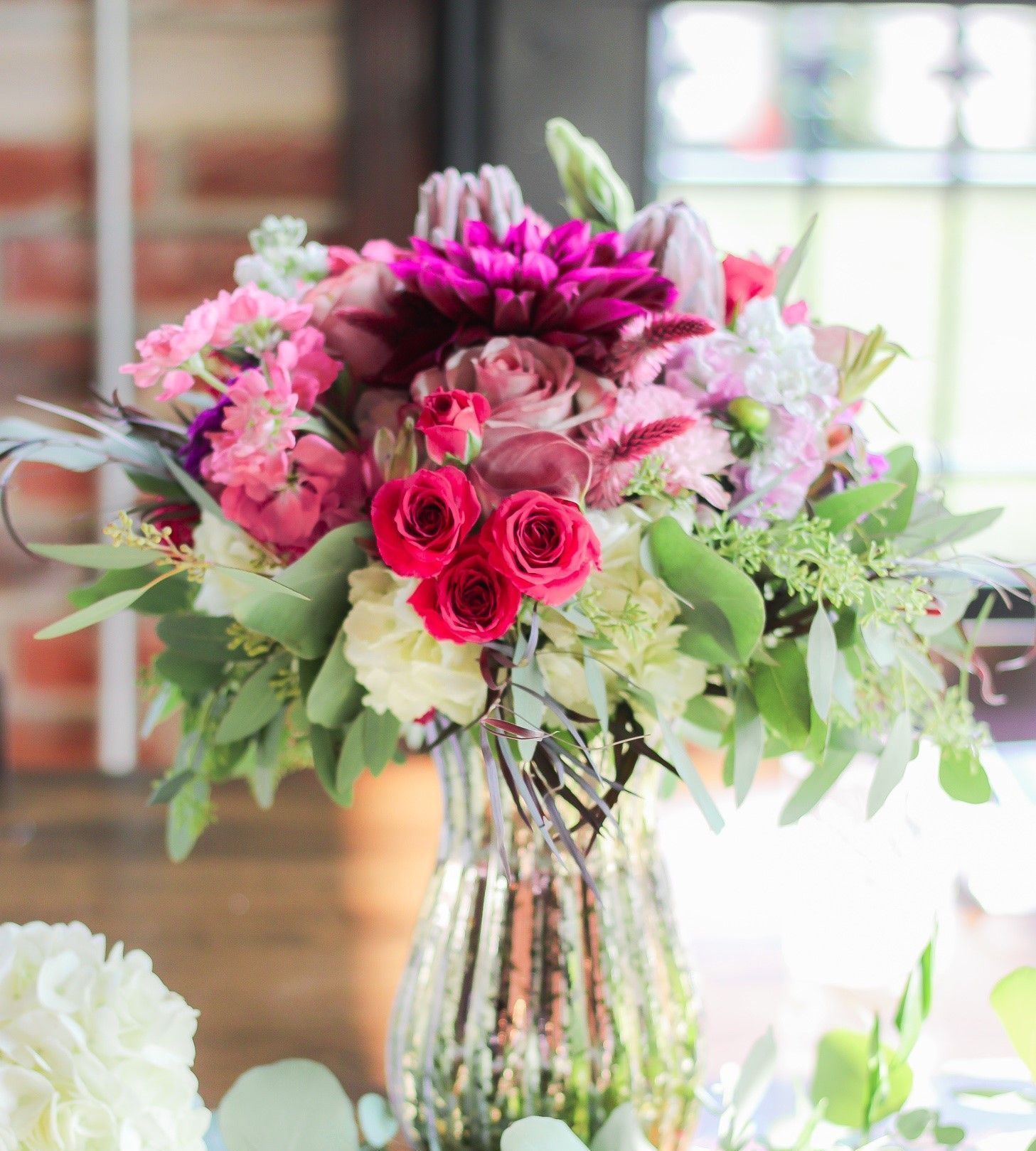 a vase filled with flowers is sitting on a table .