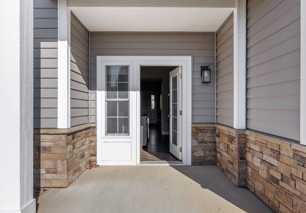 A house with a white door and a brick wall