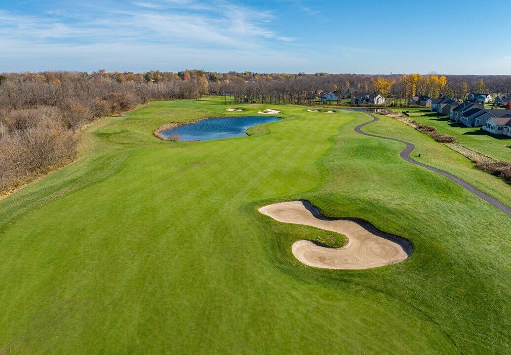 An aerial view of a golf course with a bunker in the middle of it.