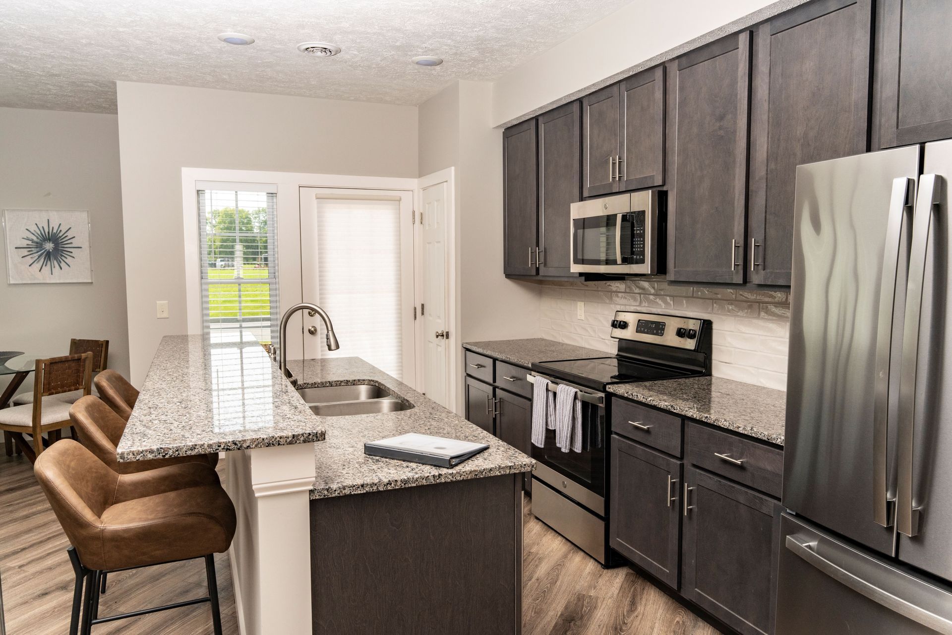A kitchen with stainless steel appliances and granite counter tops.