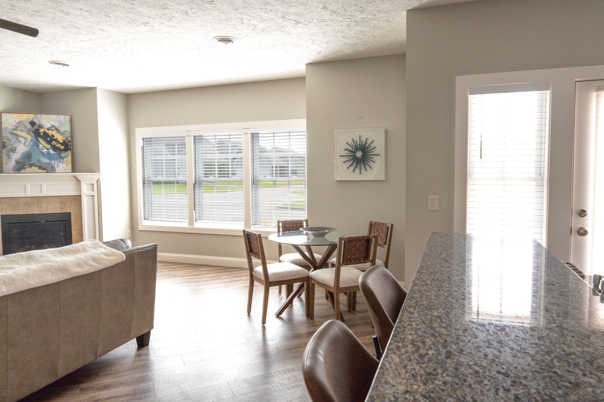 A living room with a table and chairs and a fireplace.