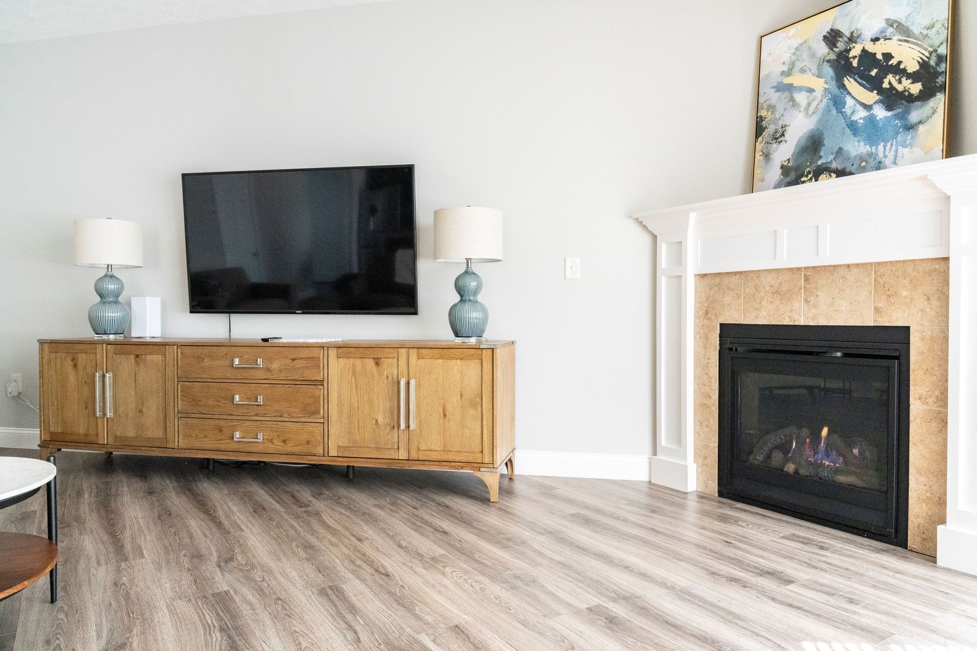 A living room with a fireplace and a flat screen tv.