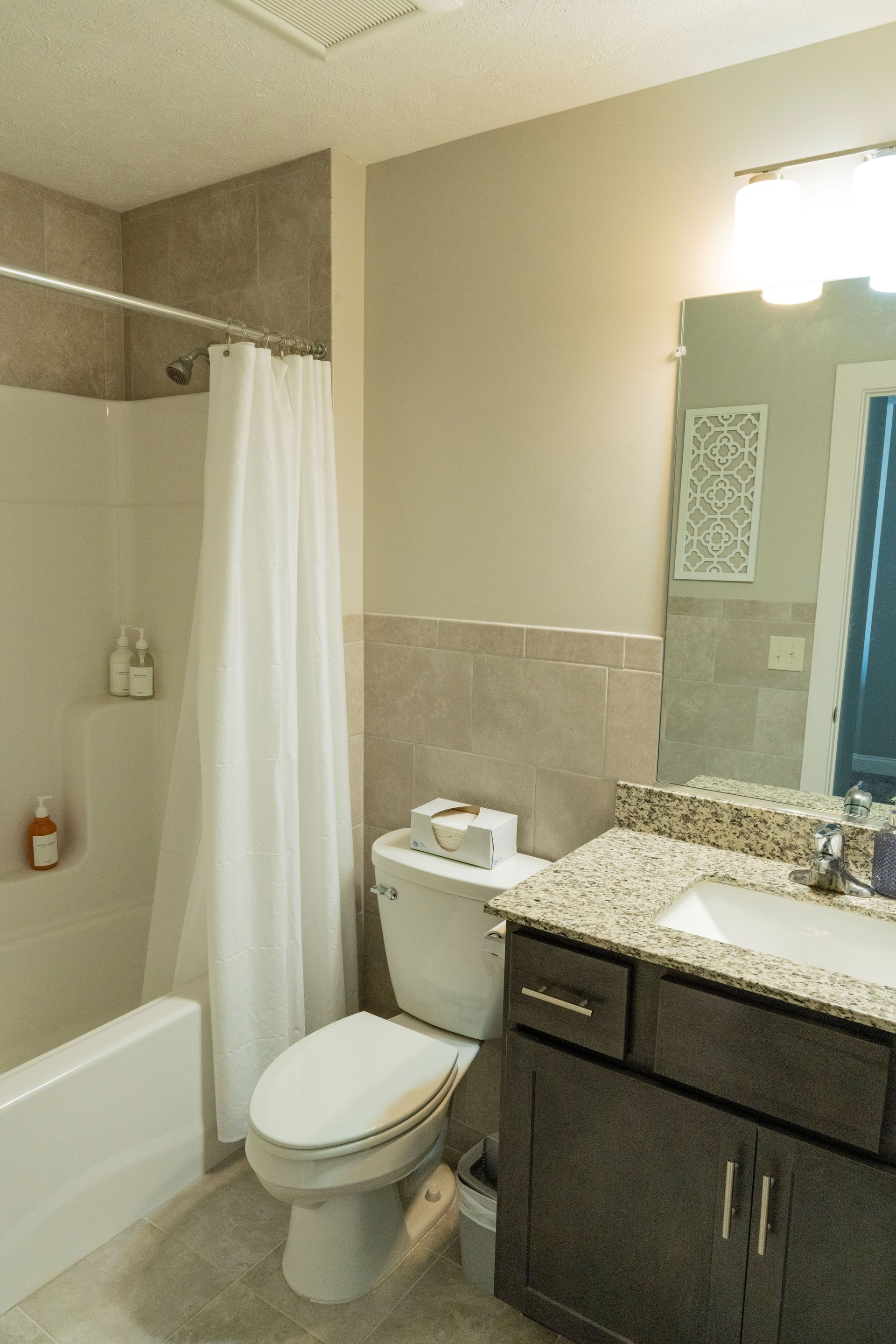 A bathroom with a toilet a sink and a bathtub