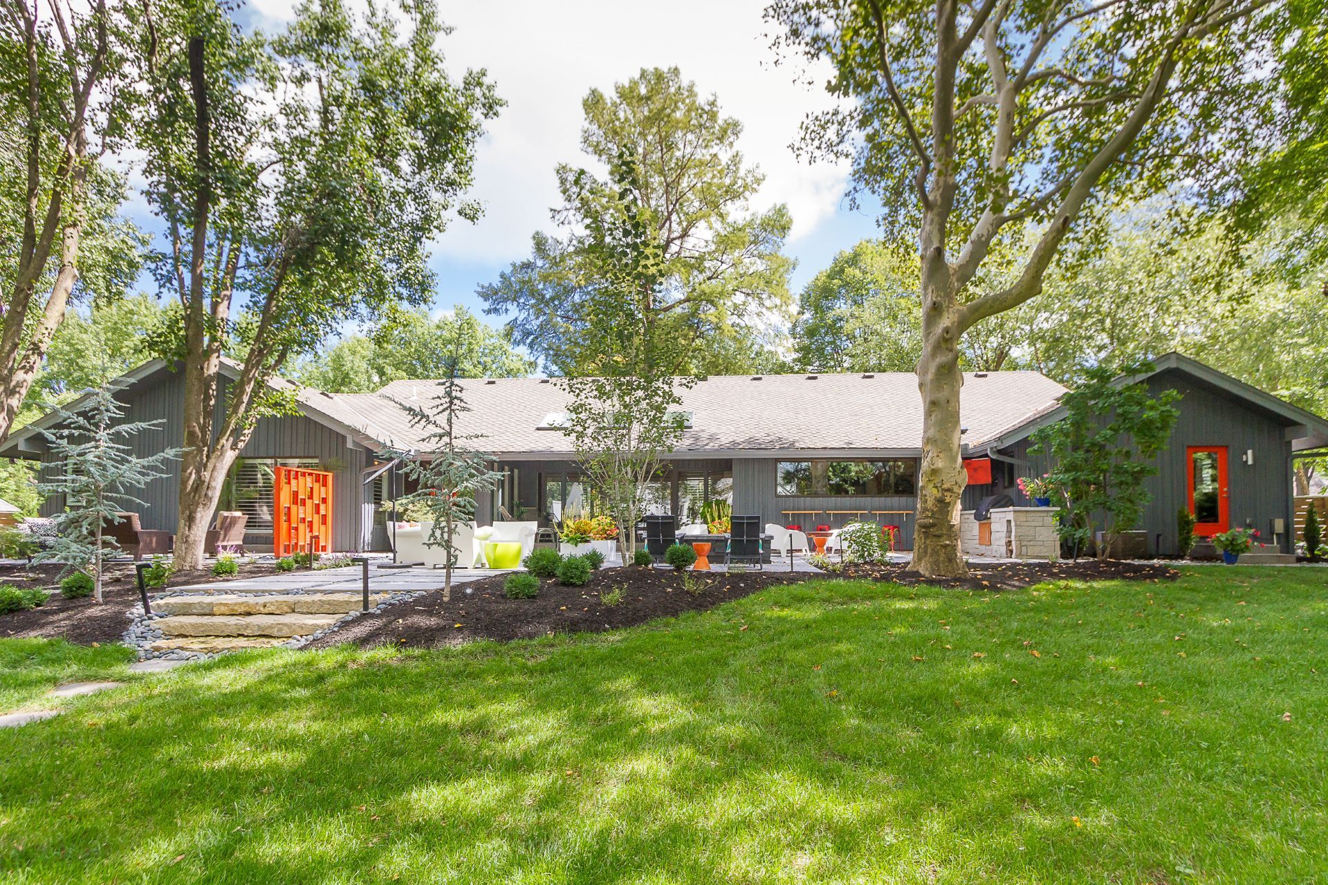 A living room with a couch , fireplace and television.