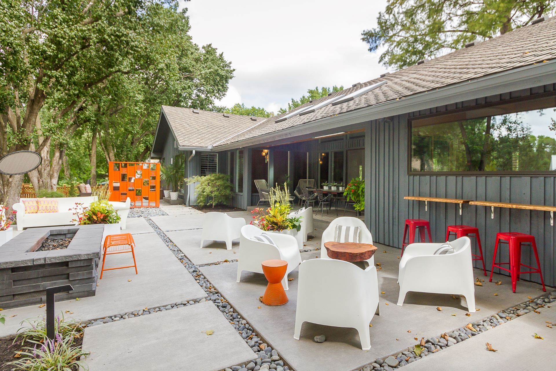 A house with a wooden door and potted plants in front of it