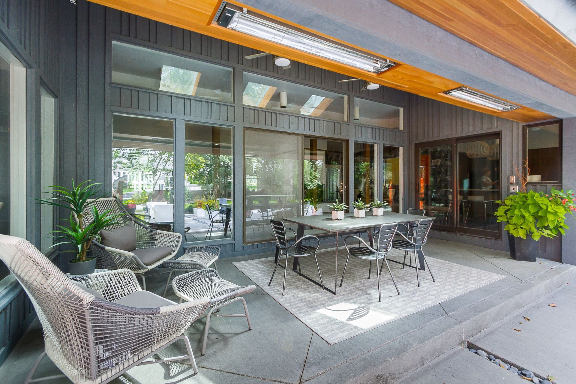 There is a patio with a table and chairs on it.