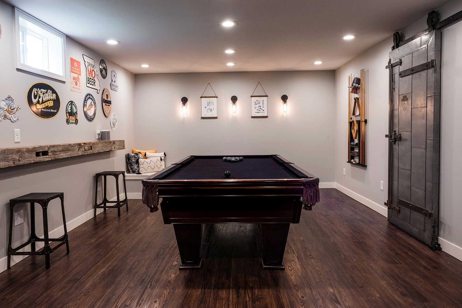 There is a pool table in the middle of the room.