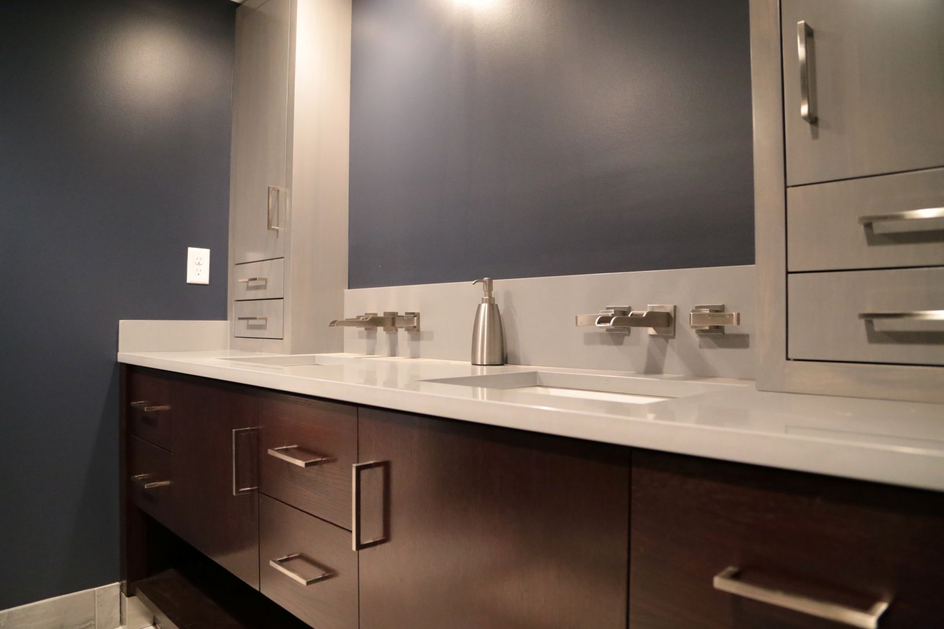 A bathroom with two sinks and a large mirror
