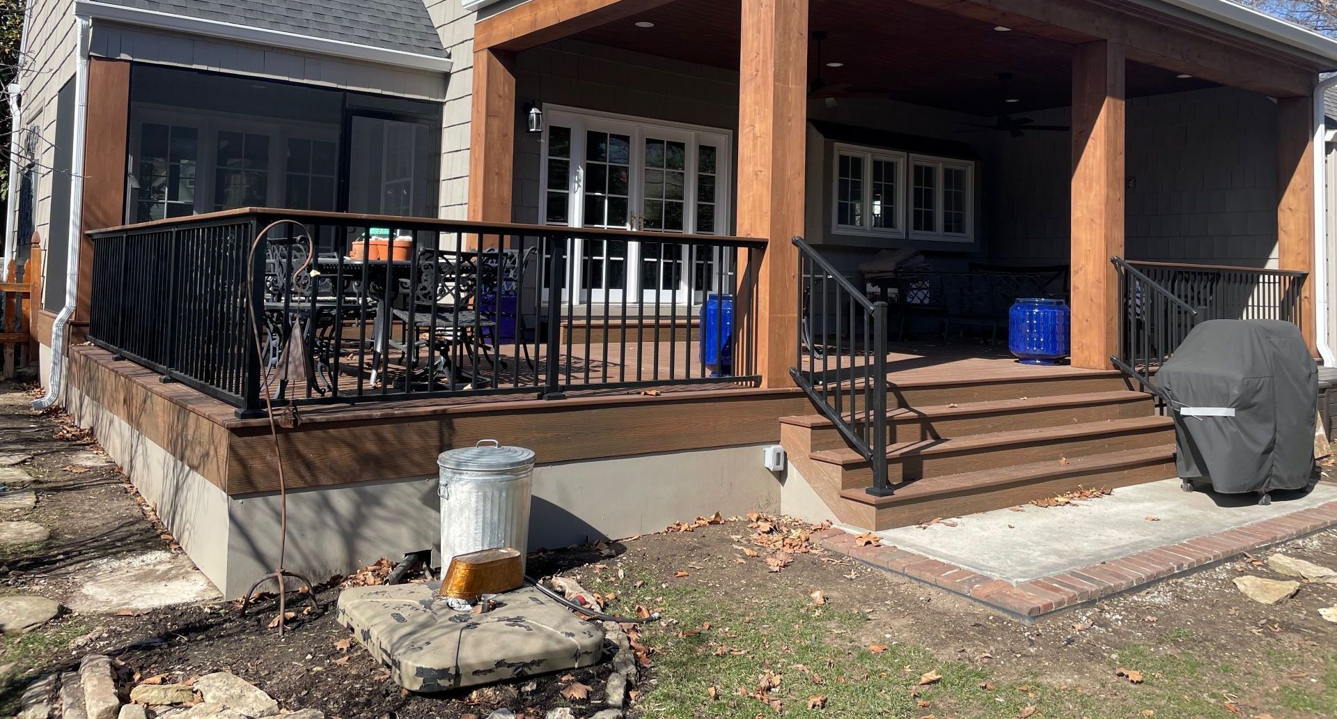 The back of a house with a large deck and stairs.