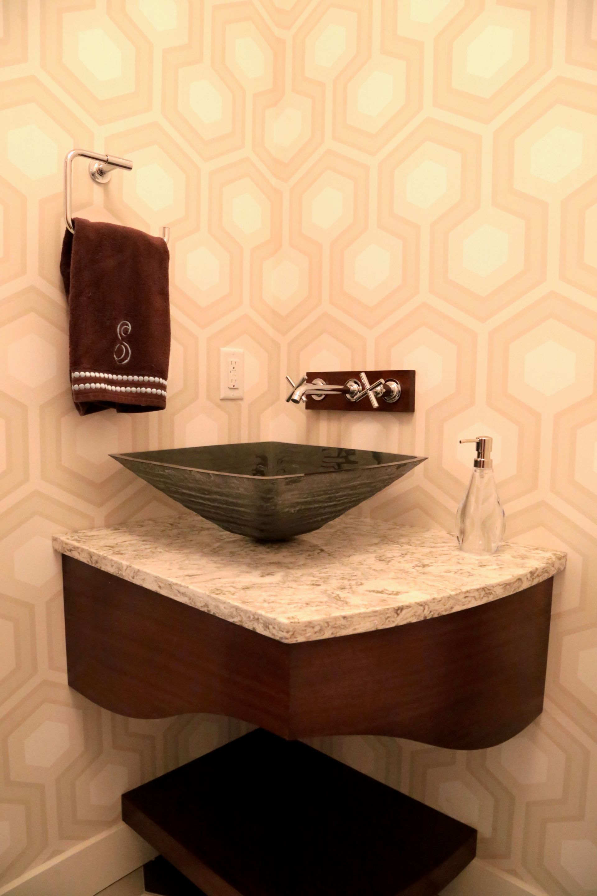 A bathroom with a sink and a towel hanging on the wall