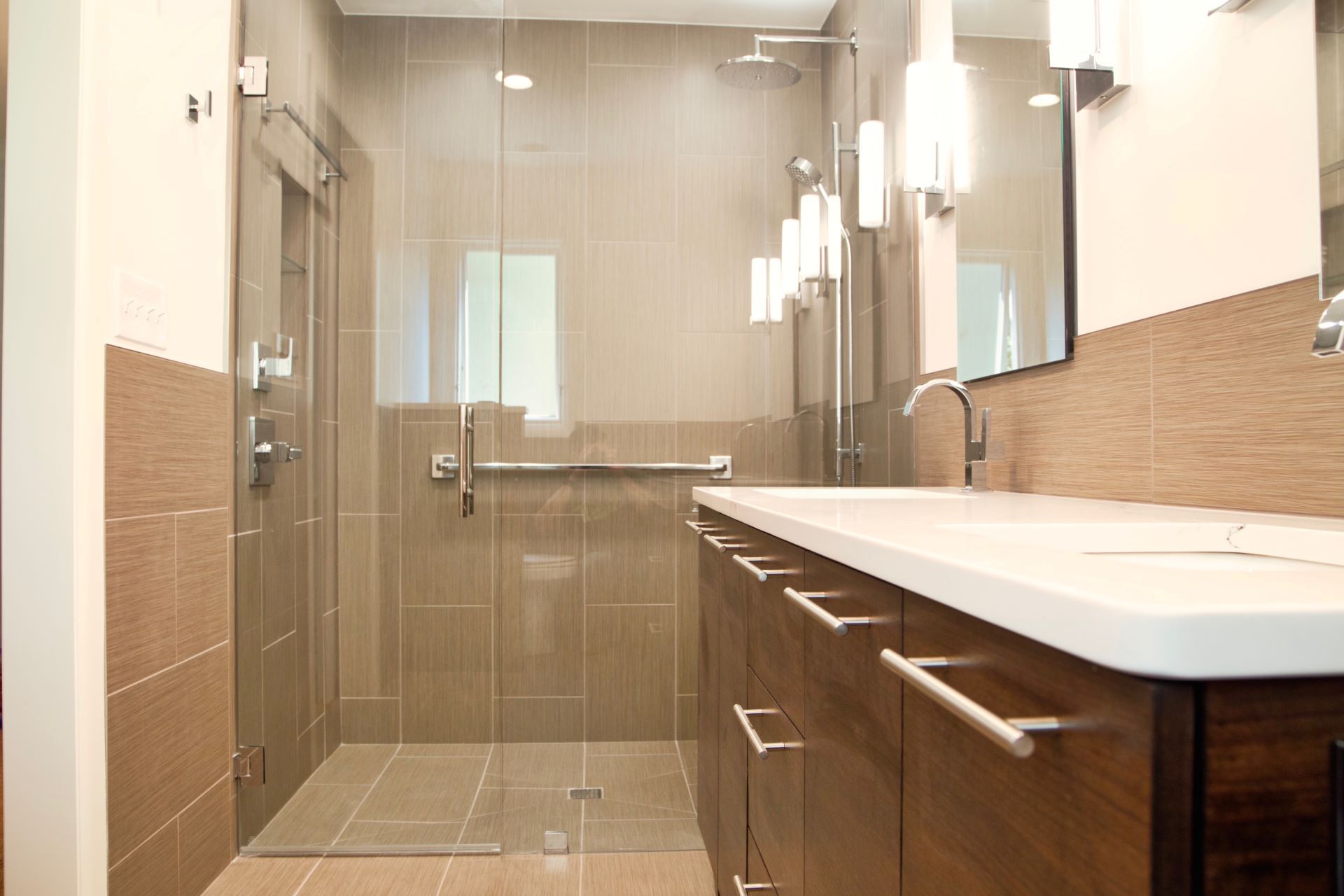 A bathroom with two sinks and a walk in shower