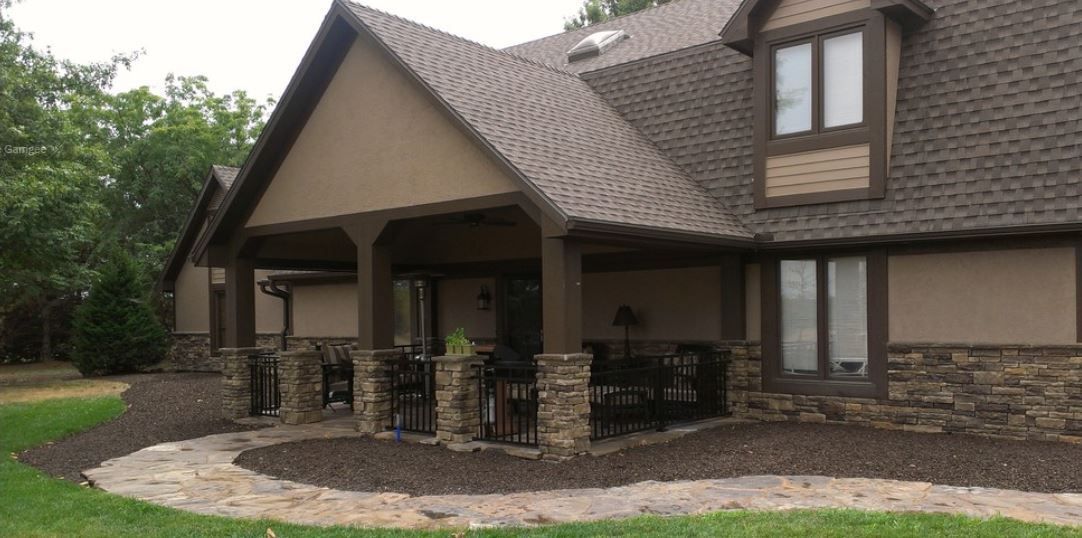 A large house with a porch and a walkway in front of it.