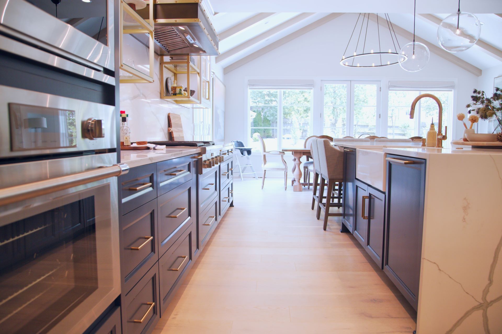 A kitchen with stainless steel appliances and a large island in the middle of the room.