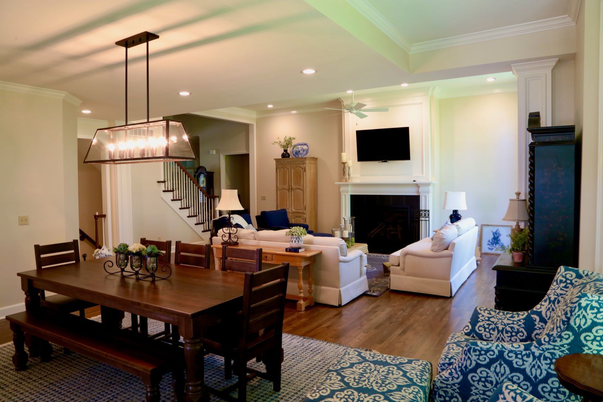 A living room with a table and chairs and a fireplace