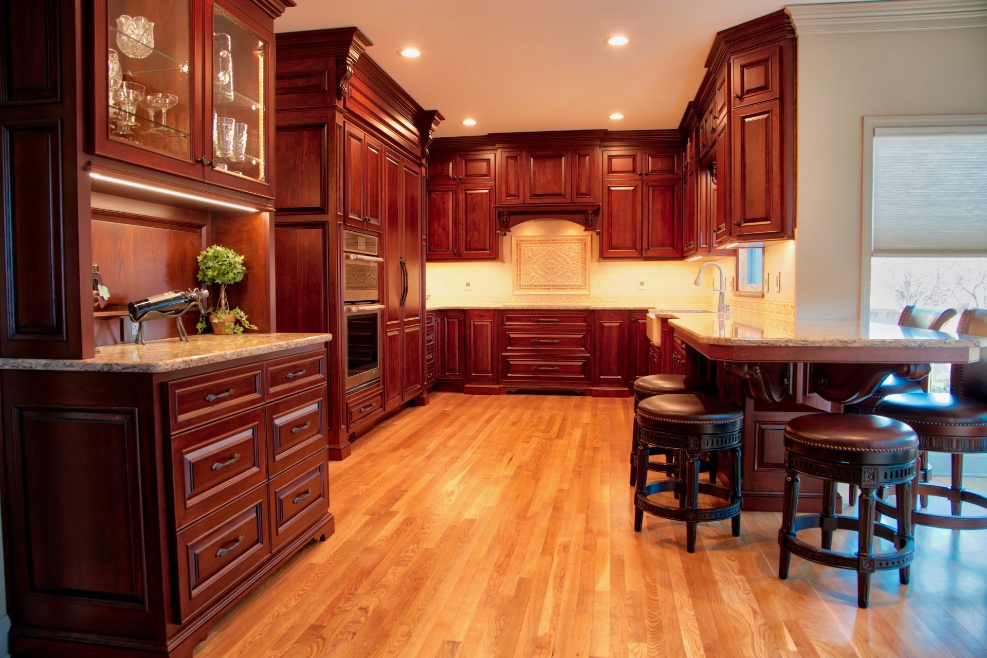 A kitchen with wooden cabinets and hardwood floors