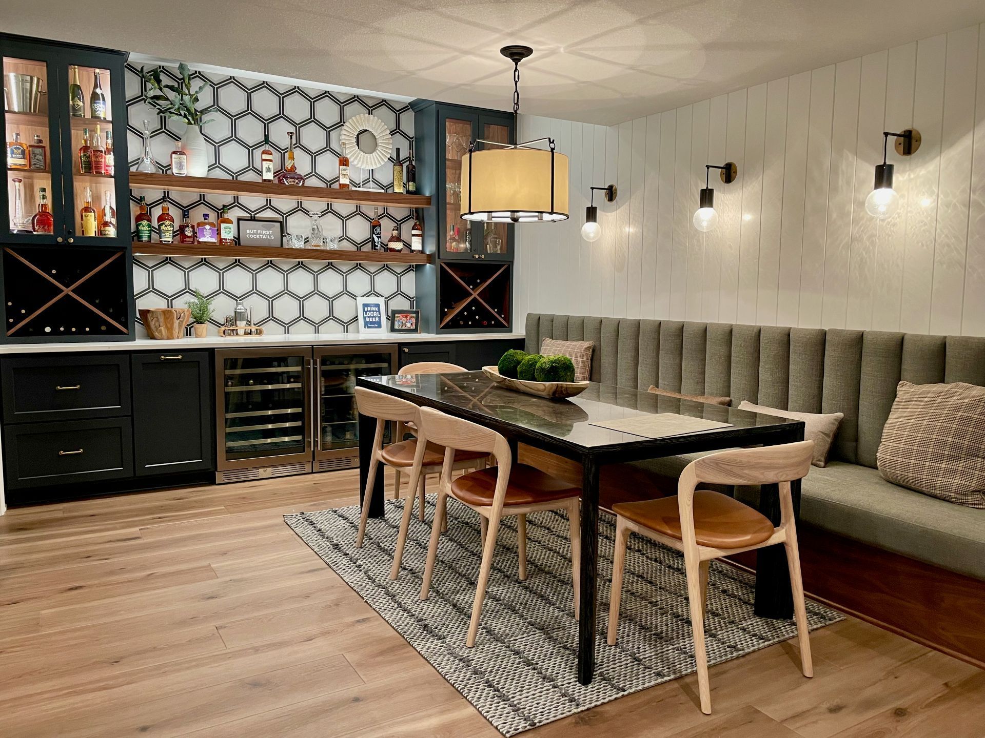 A dining room with a table and chairs and a bench.