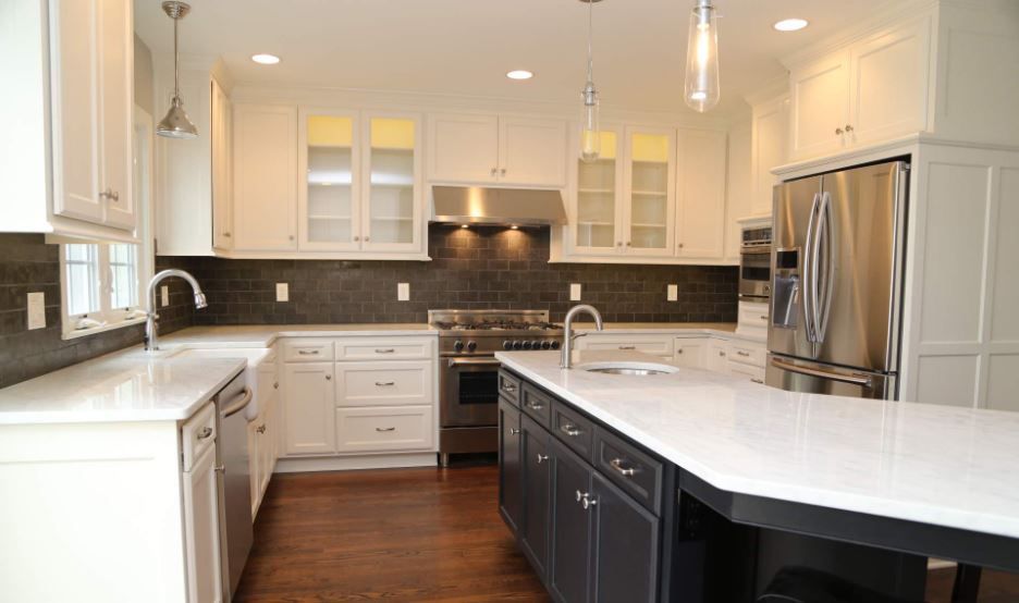 A kitchen with white cabinets and stainless steel appliances.