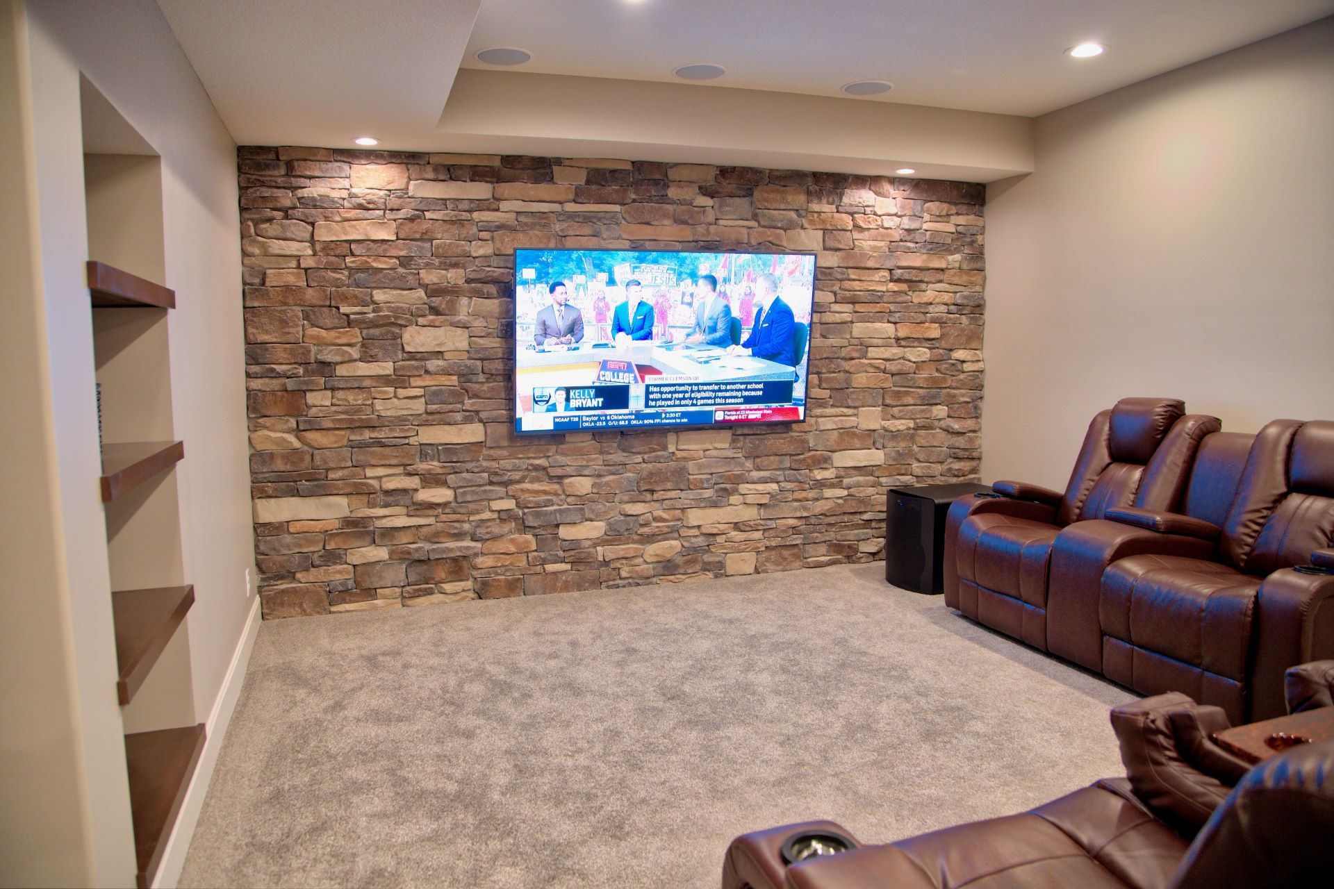 A living room with a couch , fireplace and television.