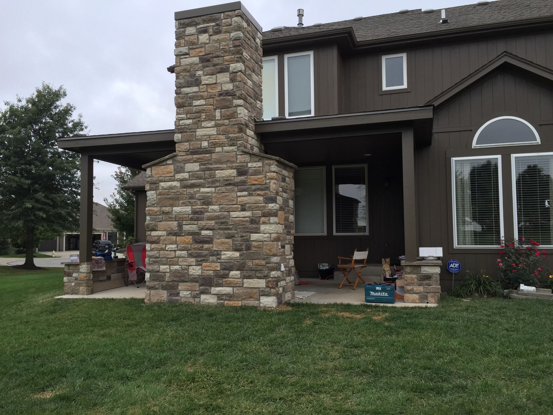 A house with a stone fireplace on the side of it