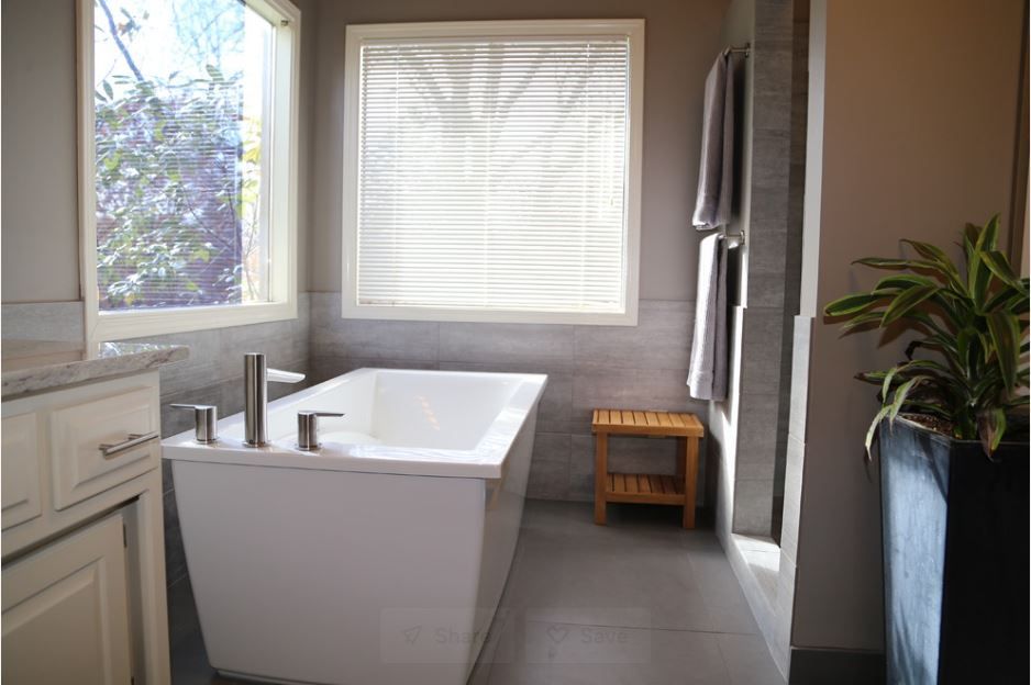A living room with a couch , fireplace and television.