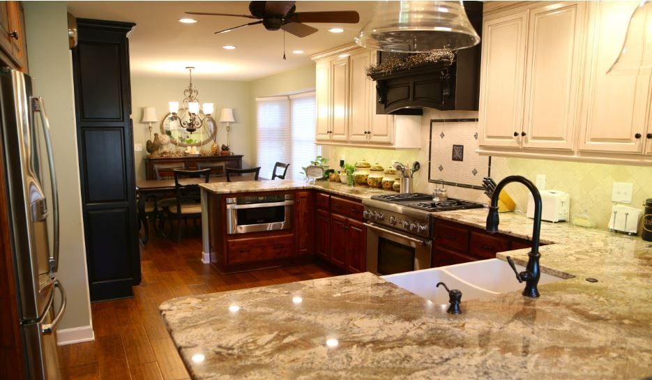 A kitchen with granite counter tops and stainless steel appliances.