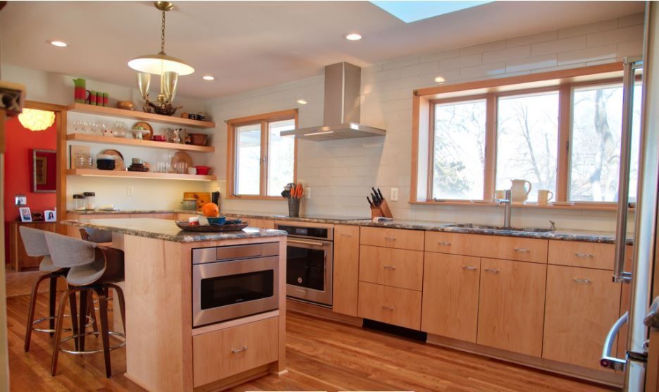 A kitchen with wooden cabinets and stainless steel appliances