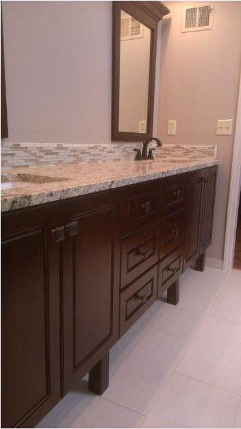 A bathroom with two sinks and a mirror