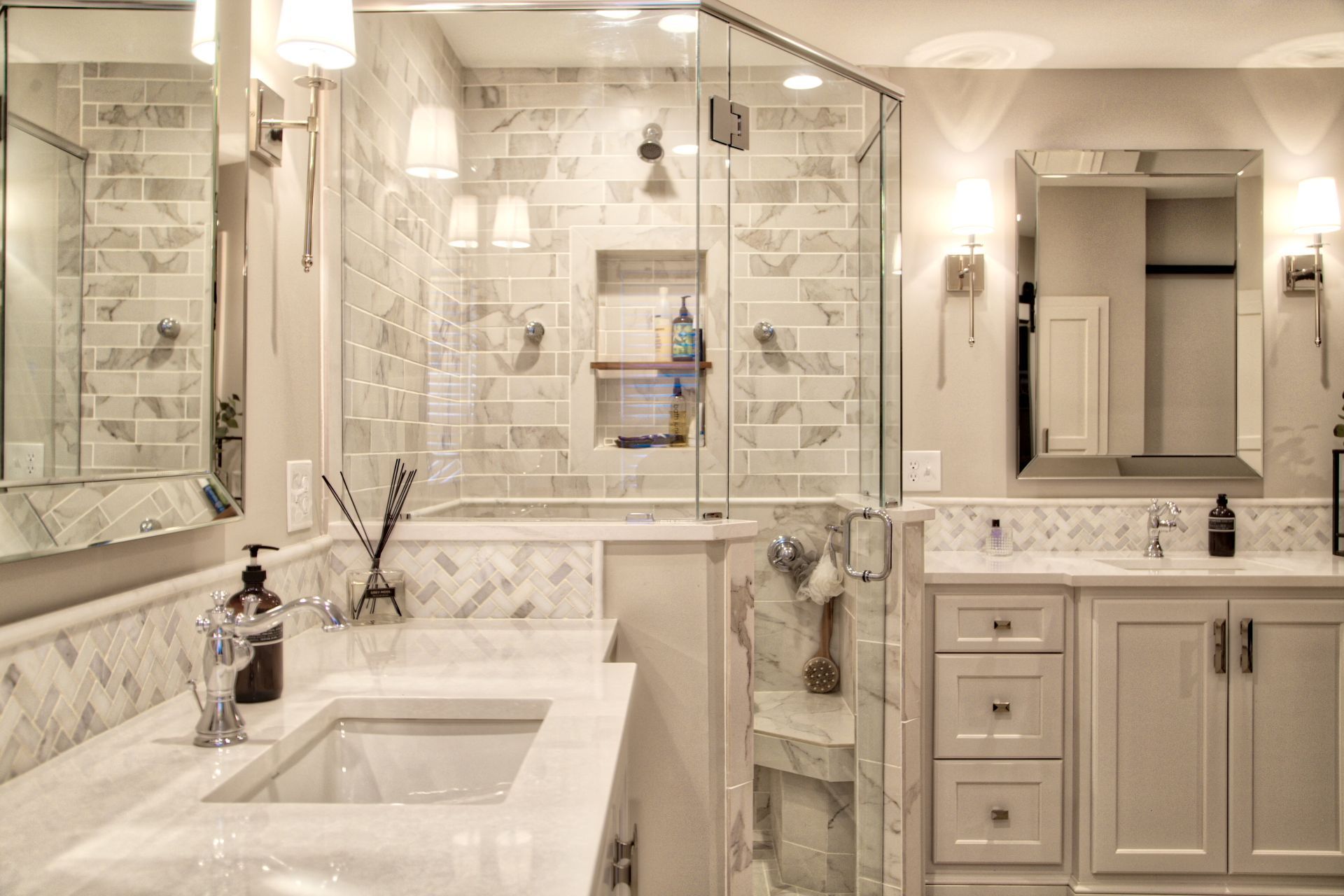 A bathroom with two sinks and a walk in shower.