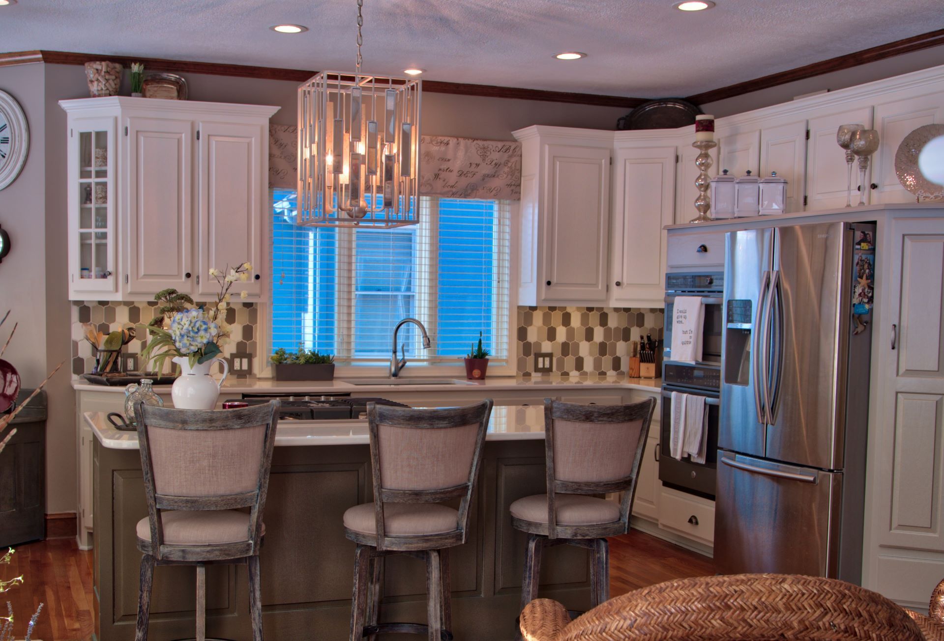 A kitchen with white cabinets and stainless steel appliances