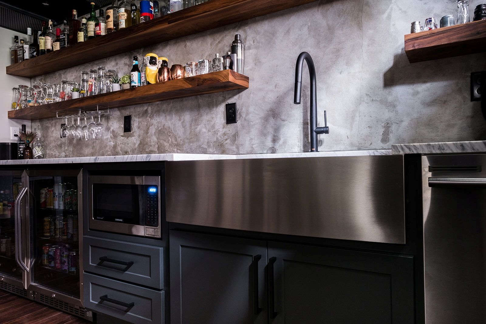 A kitchen with a stainless steel sink and a microwave.