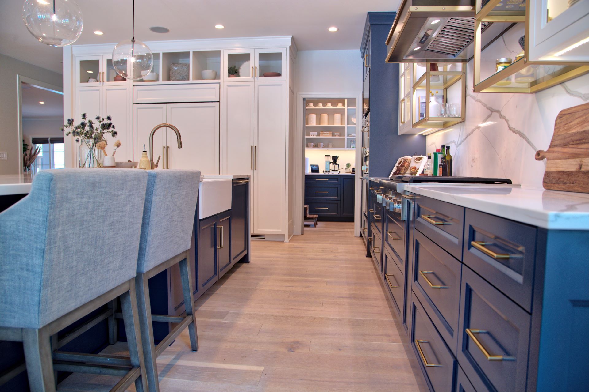 A kitchen with a lot of cabinets and drawers and a sink.