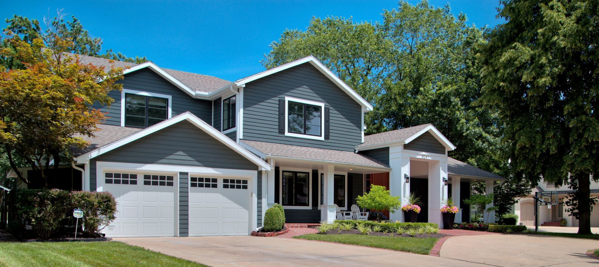 A large house with a lot of windows and a driveway.
