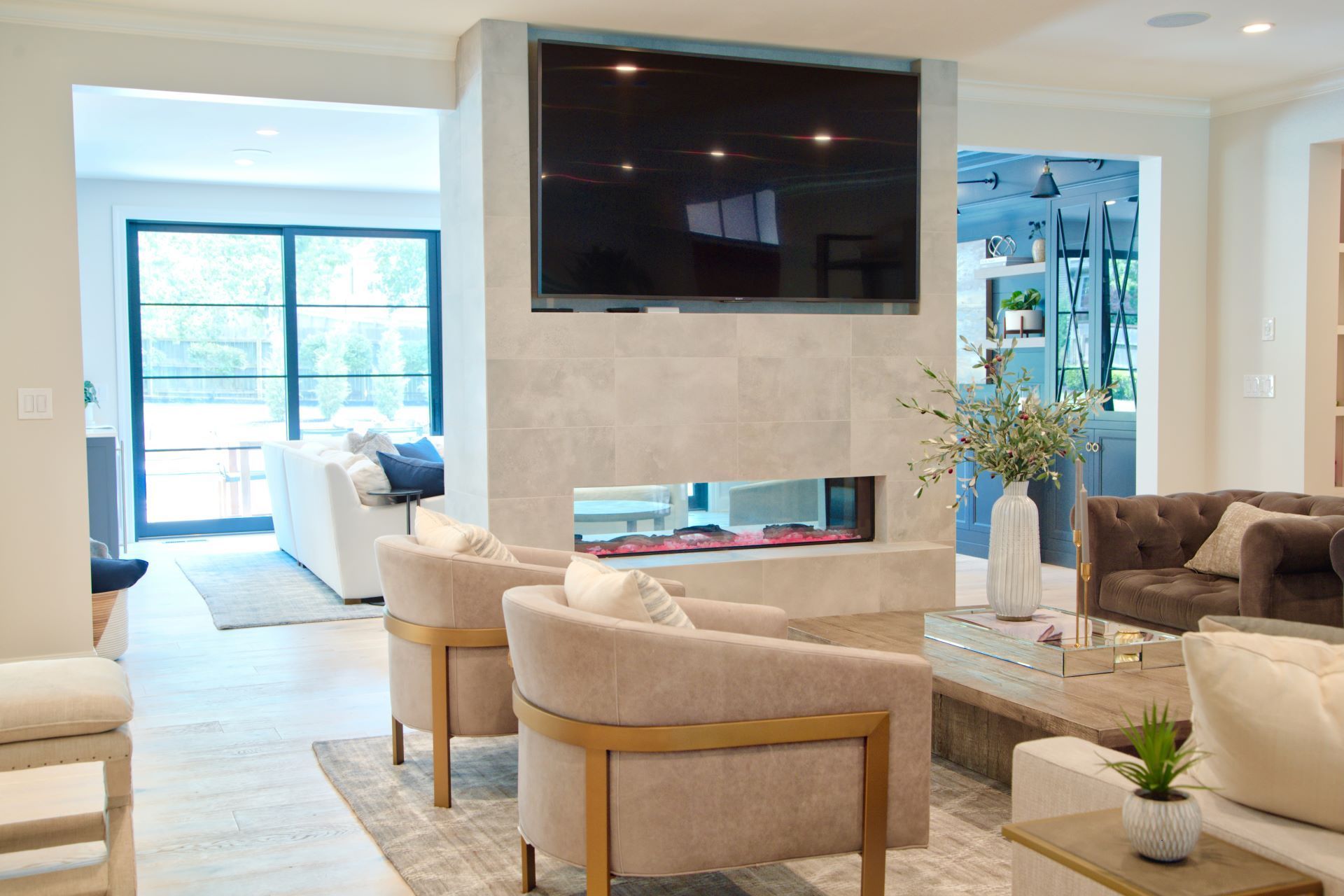 A living room with a fireplace and a flat screen tv on the wall.