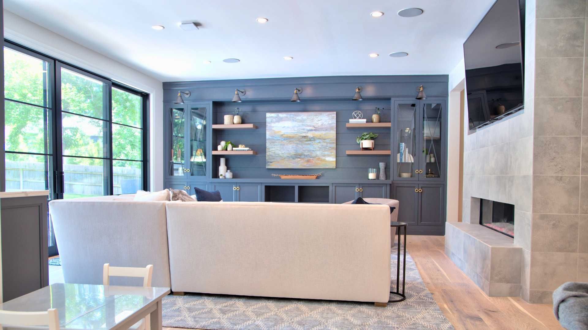 A living room with a couch , fireplace and television.