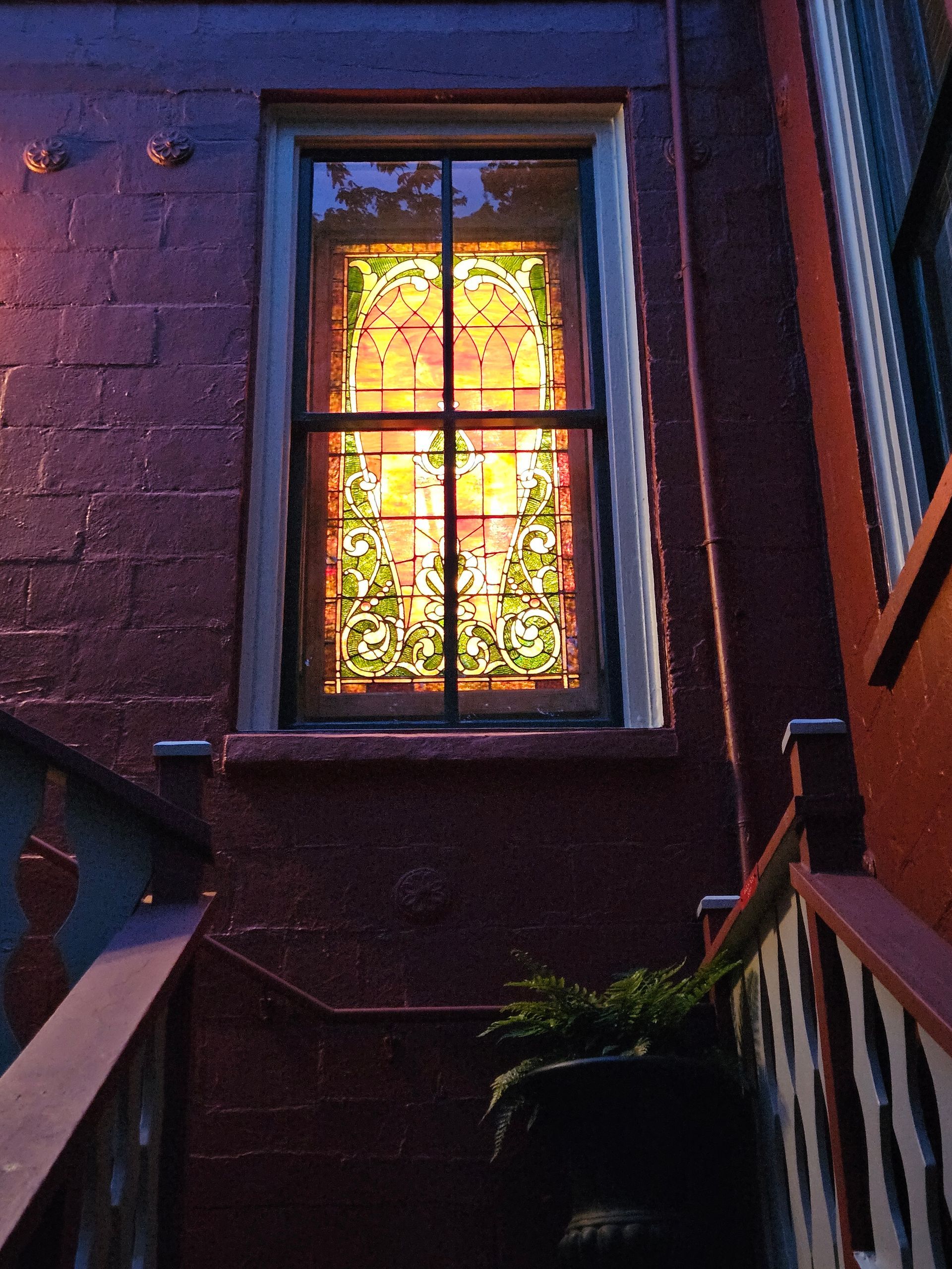 A stained glass window on the side of a building