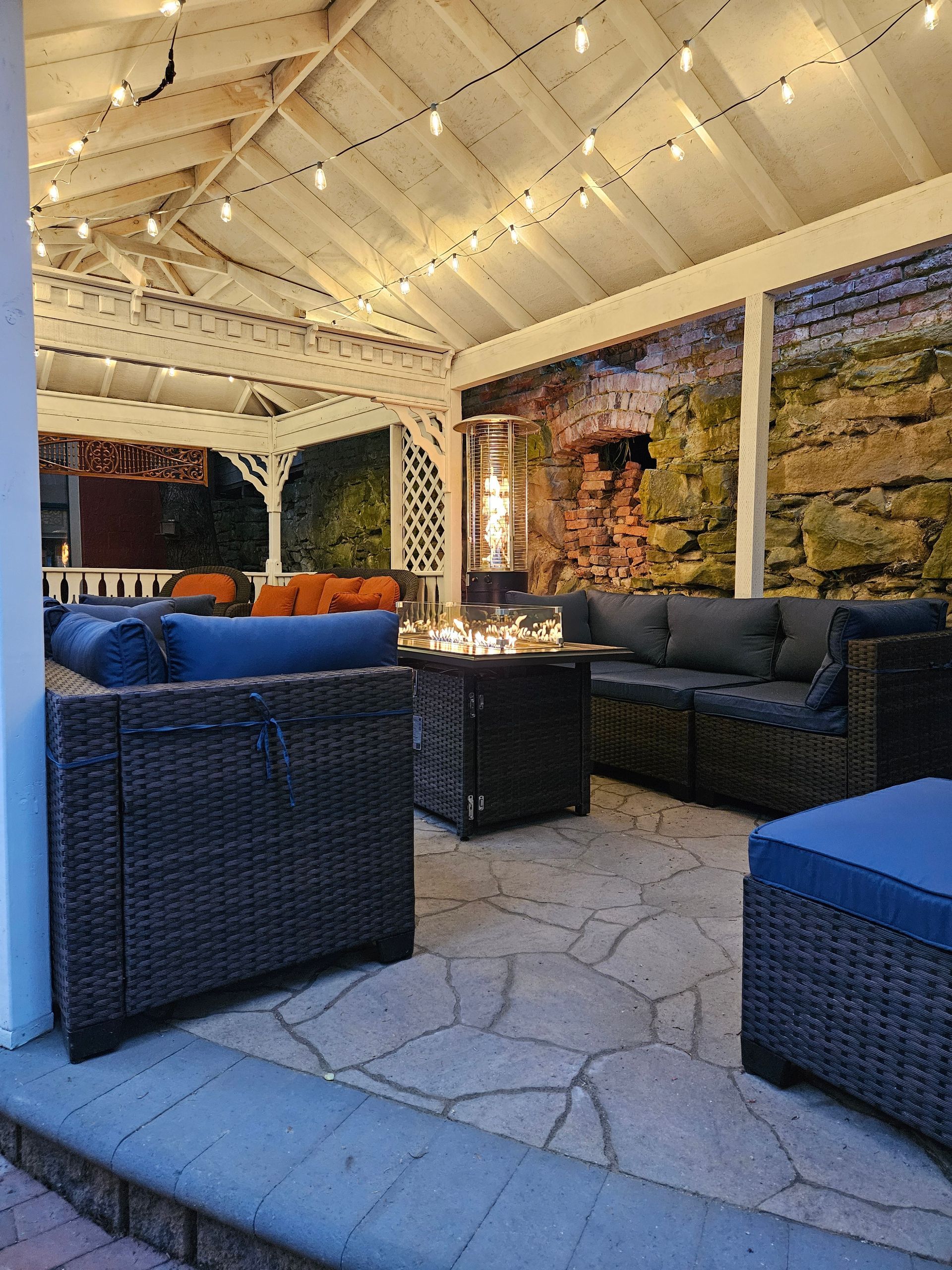 There is a fire pit in the middle of the patio.