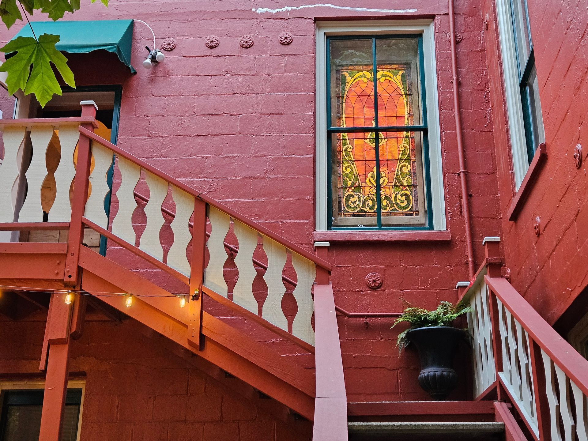 A red brick building with stairs and a window