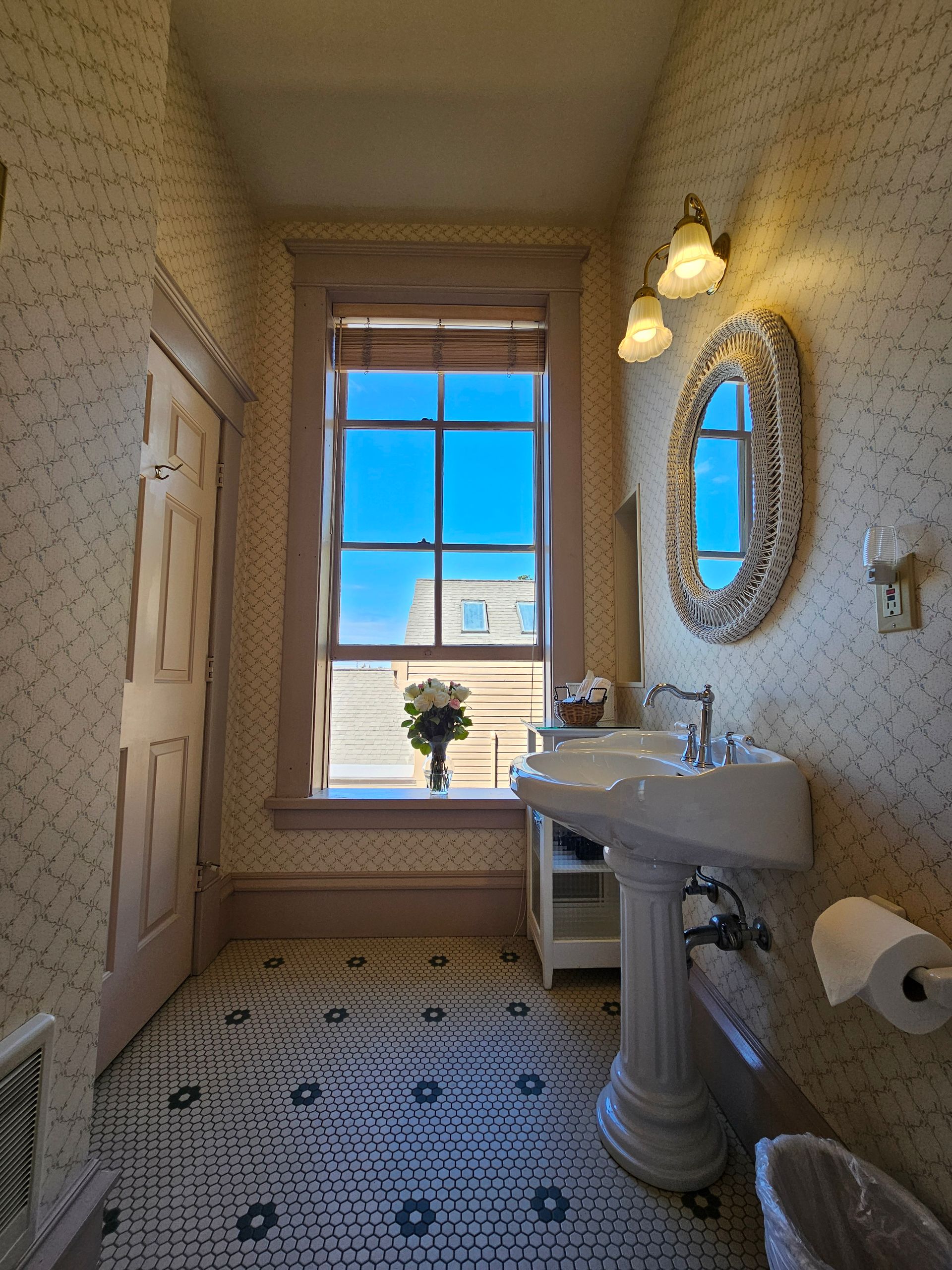 A bathroom with a sink a mirror and a window